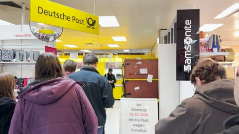 People in line at a German post office inside a department store Stock Footage 332117420