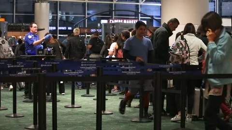 People in line going through airport security checkpoint before traveling. Stock Footage