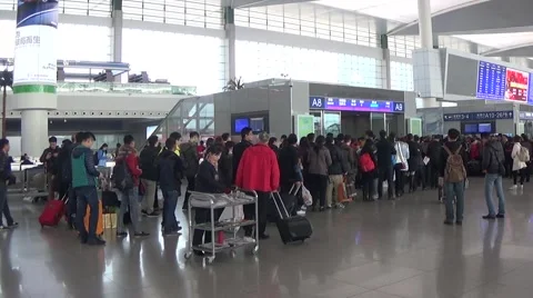 People line up a long queue and get in the ticket barrier in the waiting room Stock Footage 44839934