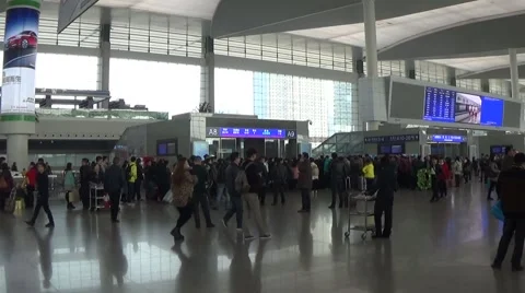 People line up a long queue and get in the ticket barrier in the waiting room Stock Footage 44841531