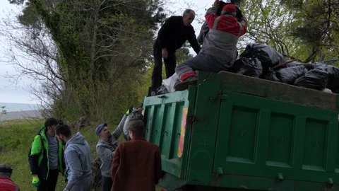 People load garbage truck with garbage bags Stock Footage 188465166