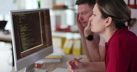 People look at the code on the computer screen, close-up Video stock 243924818