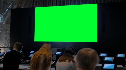 People looking at blank large interactive wall display - green screen concept Video stock 122739668