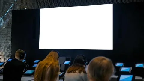 People looking at blank large interactive wall display - white screen concept Stock Photos