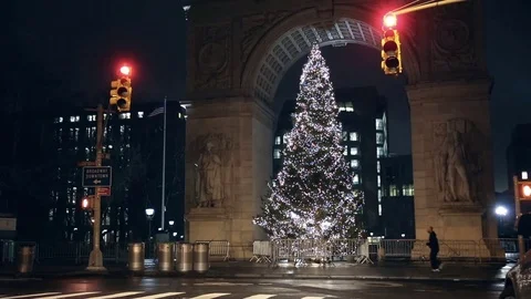 People looking at Christmas tree under Washington Square Park arch at night NYC Stock Footage 71166679