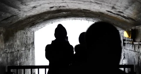 People looking at Niagara falls behind the waterfall closer Video stock 229600180