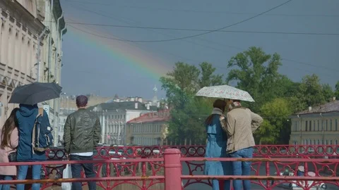 People looking at the rainbow in the city Video stock 80249567