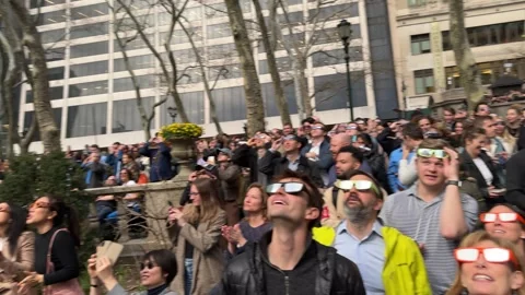 People looking at solar eclipse in New York City on April 8th, 2024 Stock Footage 271310196