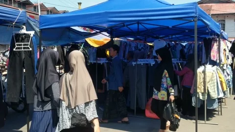 People looking for used clothes or auctions Stock Footage 247839887