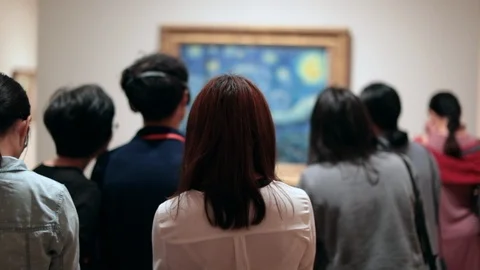People looking at a work of art. Public starring at a painting at a museum.  Stock Footage