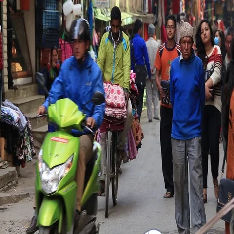 People make their way through a busy shopping street in Kathmandu, Nepal Stock Footage 69734641