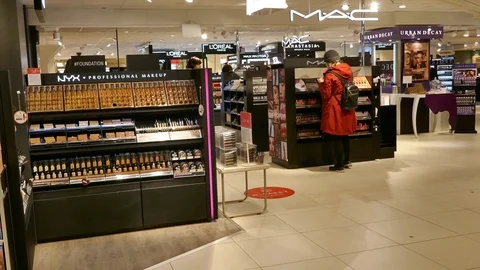 People in a makeup store looking and testing different products Video stock 112078638