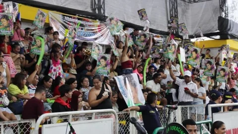 People making noise on a bleacher inside a coliseum Stock Footage 317886468