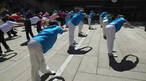 People making stretching exercises in downtown Stock Footage 51332876