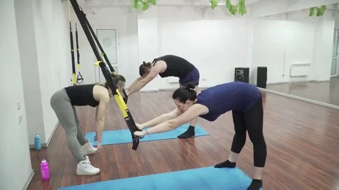 People making TRX bands in the fitness hall Stock Footage