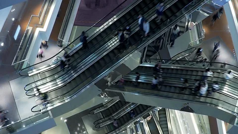 People on many fast moving Escalators In big modern shopping mall. Consumption Stock Footage 124677282