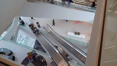 People on many fast moving escalators in modern building. Very busy full of clie Stock Footage 128295619
