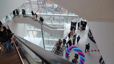 People on many fast moving escalators in modern building. Very busy full of clie Stock Footage 128295669