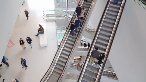 People on many fast moving escalators in modern building. Very busy full of clie Stock Footage 128295696