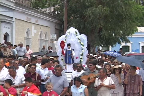 People march in a Catholic Christian procession or religious holiday parade in a Stock Footage