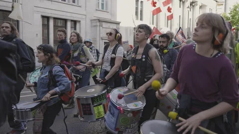 People Marching and Playing Drums at a Protest Stock Footage 263815521