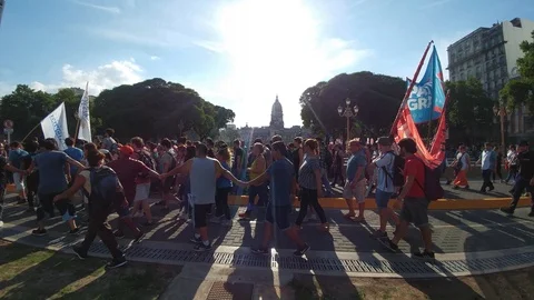 People marching in foreground with capitol building in background Stock Footage 100161192