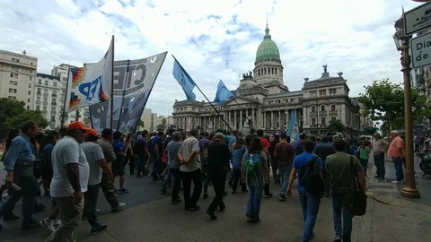 People marching in front of pretty architecture building during a protest - Stock Footage 104037529
