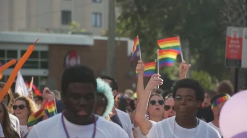 People Marching in Street With Pride Flags at River City Pride Parade in Stock-Footage 117582758