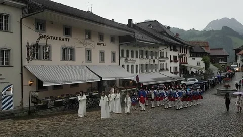 People marching through the town square in Gruyeres in Switzerland Video stock 130409571