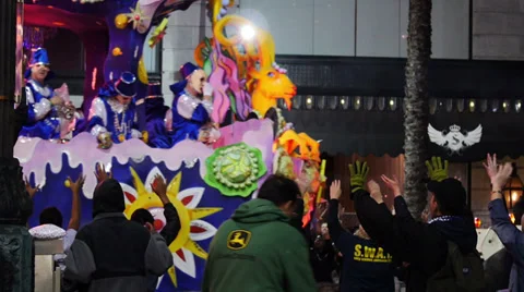 People on a Mardi Gras Parade Float Toss Beads to People Below 4123 Stock Footage 35841464