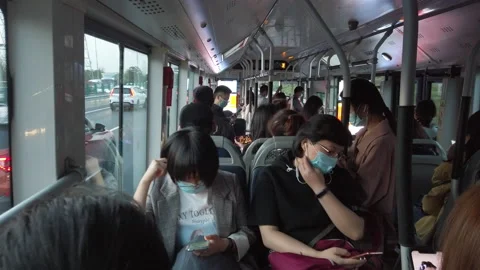 People with masks commuting on bus from work to home, Beijing, China Stock Footage 140391754