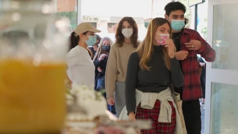 People with masks queue to enter restaurants in batches due to COVID-19 Stock Footage 168263322
