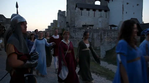 People in medieval clothes pass by Stock Footage 36366557