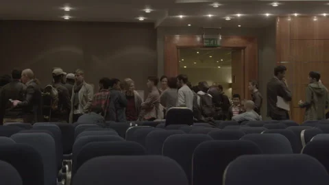 People mingling and conversing in an auditorium hall Stock Footage 342566495