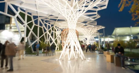 People in a modern square in the futuristic city by night Stock Footage 59121932