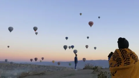 People on the mountain are looking at the air balloons Cappadocia Stock Footage 101459580