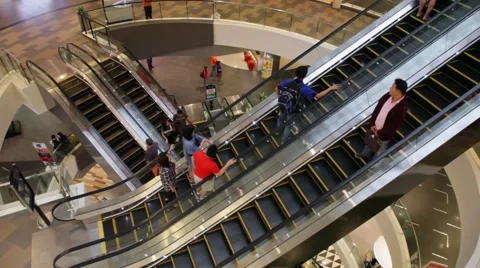 People move up and down escalators in an shopping mall in Chiang Mai, Thailand. Stock Footage 51778415