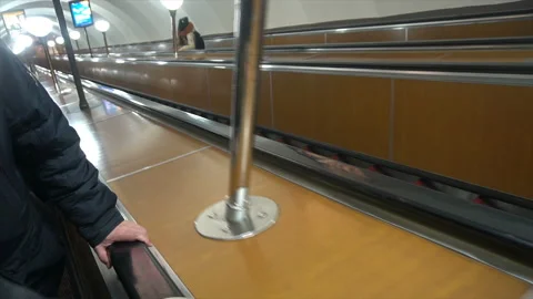 People move on an escalator,human hand on the railing Stock Footage 99478566