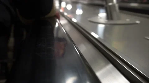 People move on an escalator,human hand on the railing Stock Footage 99479619