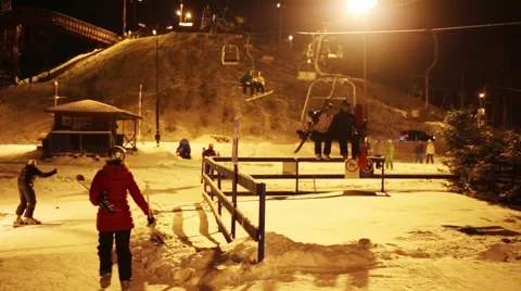 People move on funicular at night and skiers in ski resort Video stock 63030271