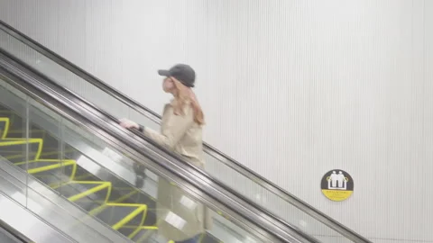People moving on escalator . Stock Footage 239964699