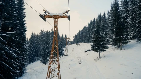 People moving up the snow forest on ski elevator Stock Footage 120051553