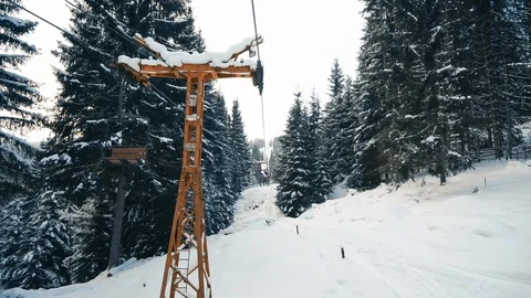 People moving up the snow forest on ski elevator Stock Footage 120051782