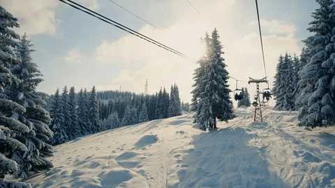 People moving up the snow mountains on ski elevator Stock Footage 120052353
