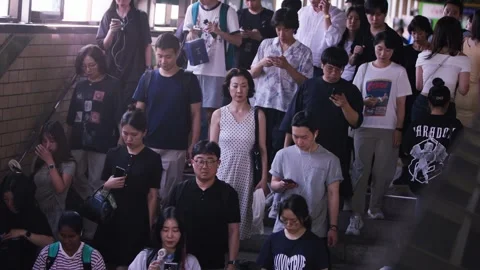 People moving through crowded Seoul metro station Stock Footage 314073374