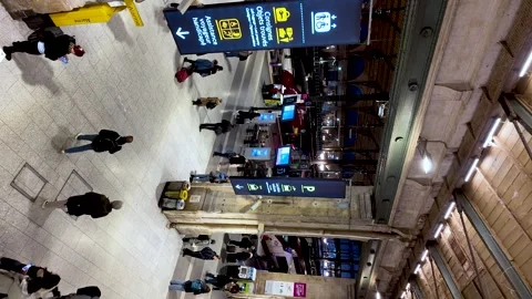 People moving through the main hall of the bustling Gare du Nord railway Stock Footage 331055357