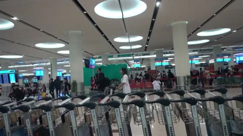 People moving with trolly inside dubai international airport Stock Footage