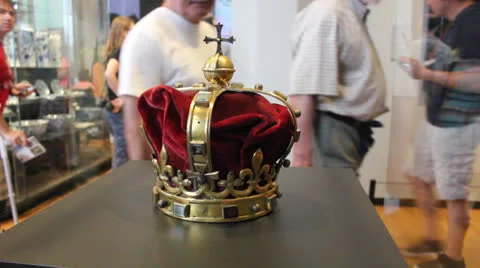 People in museum looking at kings crown Stock Footage