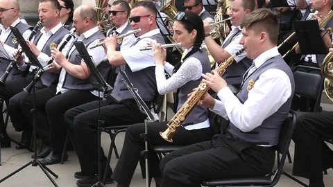 People musicians sitting play wind instruments in municipal orchestra Stock Footage