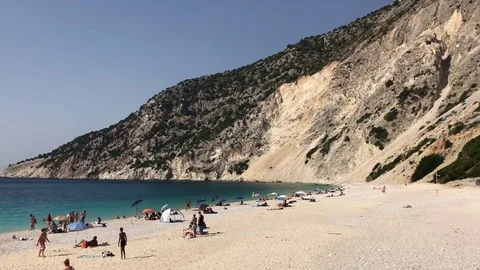 People at Myrtos beach with the reef in background in Kefalonia in Greece Stock-Footage 81327673
